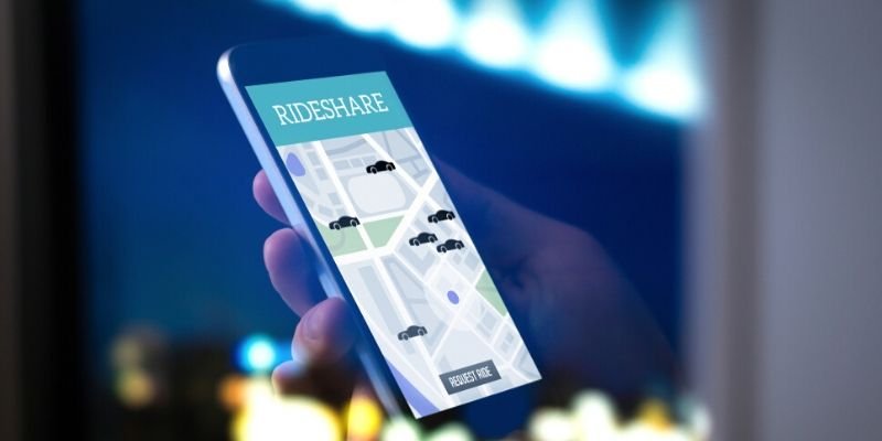 person holding phone with ride sharing app