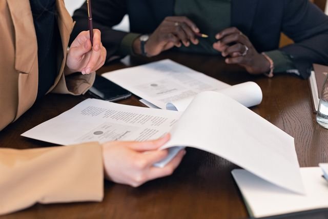 Photo by Mikhail Nilov: https://www.pexels.com/photo/a-close-up-shot-of-people-reviewing-documents-8730981/
